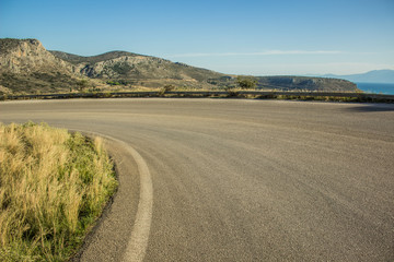 curved car road in rock mountain nature landscape in dry weather summer time Mediterranean sea district  