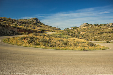 curved car road in rock mountain nature landscape in dry weather summer time Mediterranean sea district  