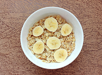 oatmeal with banana in a white bowl