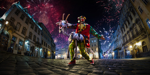 Night street circus performance whit clown, juggler. Festival city background. fireworks and Celebration atmosphere. Wide engle photo - obrazy, fototapety, plakaty