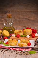 Potato gratins with mozzarella and tomatoes.