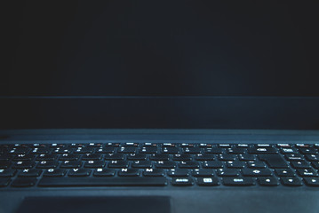 Black laptop keyboard background. Technology concept