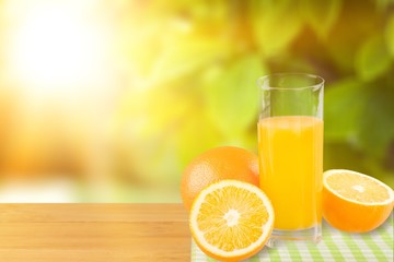 Orange juice and slices of orange on background