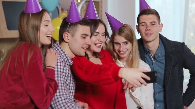 Cheerful friends taking selfie at the birthday party, good-looking young people celebrating important event