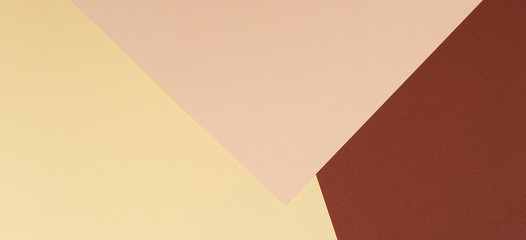 Color papers geometry composition background with yellow beige and brown tones