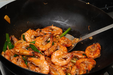 frying shrimps with wok at home