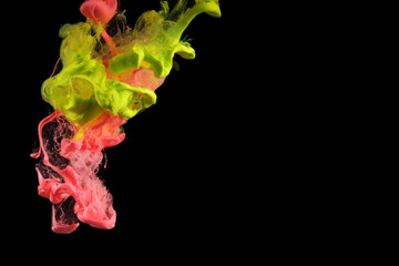 Acrylic colors in water. Ink blot. Abstract background on black.