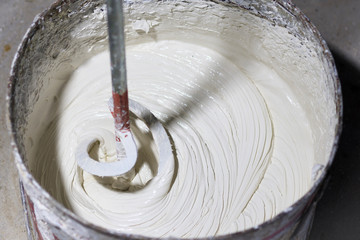 mixing white putty. General repair and renovation. Home improvement. close-up