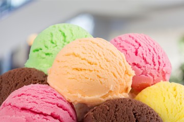 Chocolate, vanilla and strawberry ice cream in the cones on