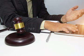 Business lawyer writing tax at office desk workplace with book and documents.