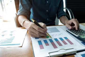 Businessman using calculator and holding money for calculate tax in office.concept