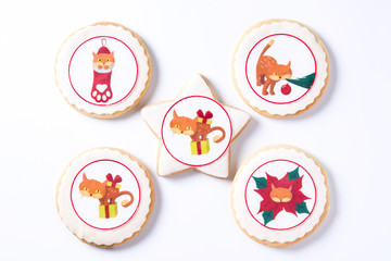 Homemade butter cookies with a printed Christmas cat design isolated on white background.Top view	
