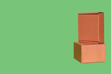 Two boxes separately on a green background isolated