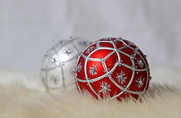 Red and silver Christmas ball on a sheep skin