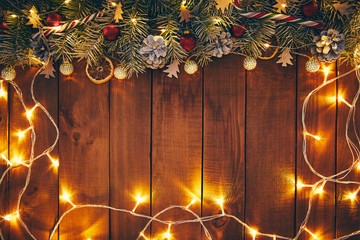 Wooden Christmas background with decorations and lights.