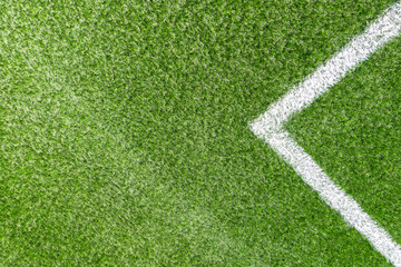 Green synthetic artificial grass soccer sports field with white corner stripe line
