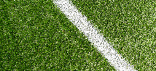 Green synthetic grass soccer sports field with white corner stripe line