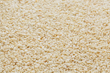 White sesame seeds background. Useful seeds for cooking