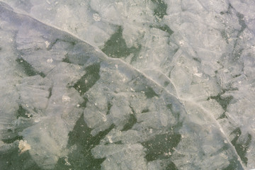 Broken ice with crack, detailed background. Winter background with natural white frost and ice.