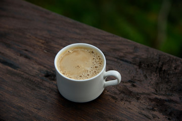 Hot latte on the beautiful nature background