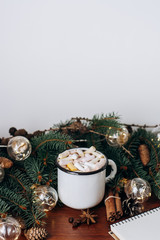 Chocolate or cocoa with marshmallow,  notebook and  garland on a wooden background.