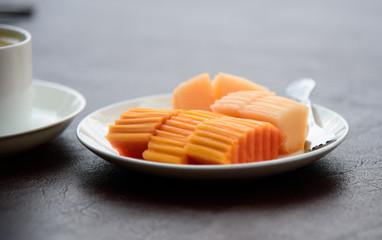 Papaya with cantaloupe in the dish has a beautiful nature as the background