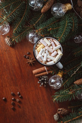 Chocolate or cocoa with marshmallow  and  garland on a wooden background.