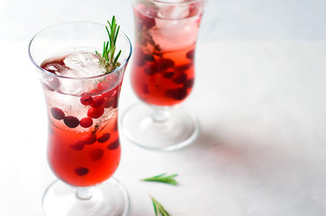 Cranberry Cocktail with Ice and Rosemary On White Background