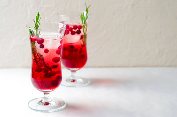 Cranberry Cocktail with Ice and Rosemary On White Background