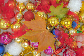 Christmas background image of colorful balls and dry leaf.