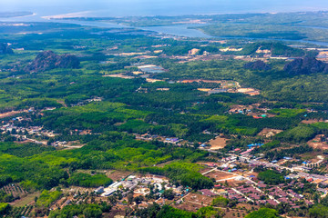 Fototapeta na wymiar View of the Krabi province from the plane aircraft, the river flowing into the Adaman Sea, the rainforest, roads, houses from a bird's eye view. Krabi Town aerial view, Thailand.