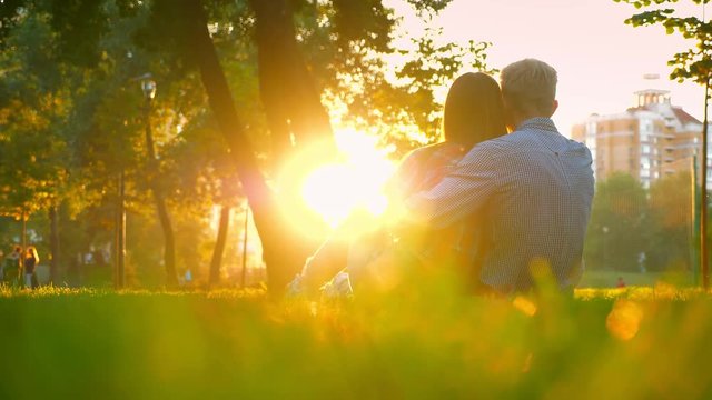 Couple of woman adn man are lovely sitting and holding each other in the park, when sun is shining their silhouettes and giving hope for future happy life, park view, modern illustration