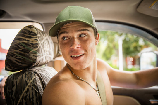 Young Man in Truck Looking Over Shoulder