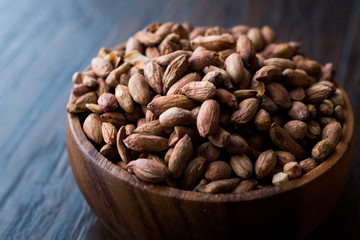 Organic Pistachio Nuts Without Shell in Wooden Bowl.