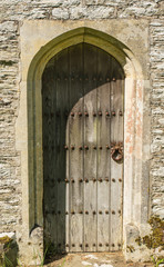Fototapeta na wymiar Old wooden doorway to church in England