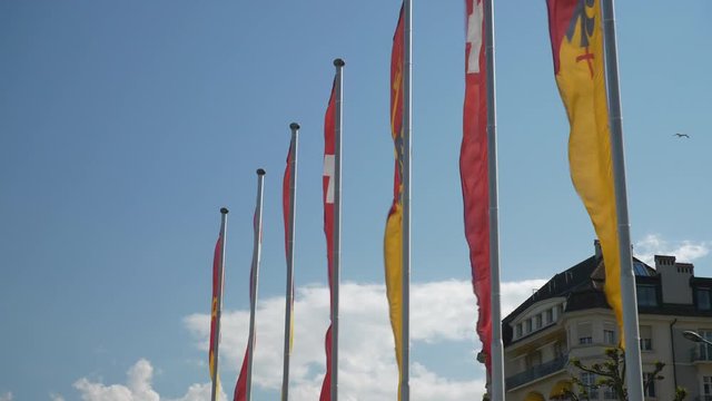 sunny day geneva city lakeside flags slow motion panorama 4k switzerland
