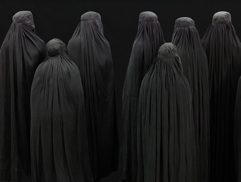 Seven women in burqas