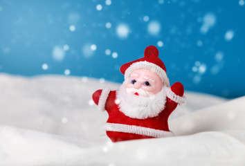 Naklejka na ściany i meble santa claus figurine standing on the snow. christmas and new year season concept