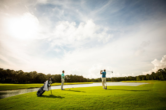 Men Teeing off for a Game of Golf