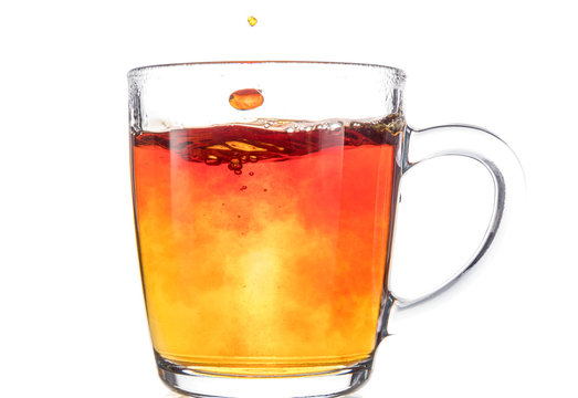 Brewing A Tea Bag In A Transparent Mug With Sugar On A White Background, A Storm In A Glass