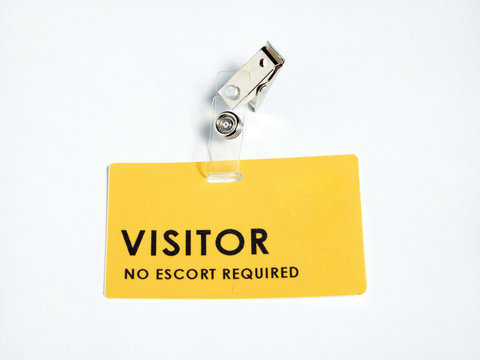 A yellow visitor's pass