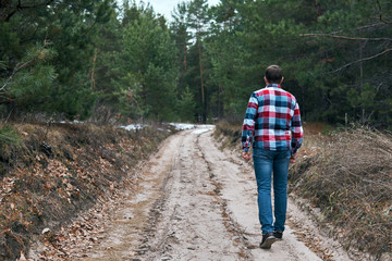 Fototapeta na wymiar Anonymous man walking in forest