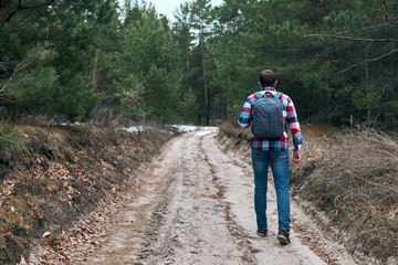 Obraz premium Anonymous man walking in forest