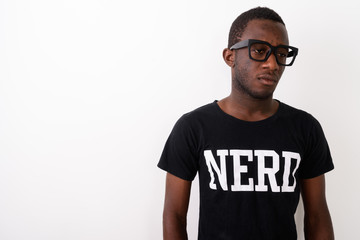 Studio shot of young black African geek man wearing Nerd shirt w