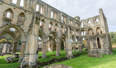 Fototapeta premium The ruins of the church Abbey. A shell of a building, stone walls and window arches largely intact but no roof