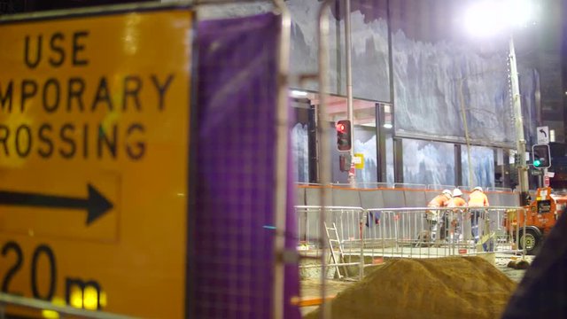 Pan Across Sydney Construction Site with Resting Workers
