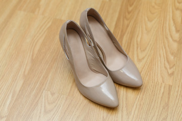 beige high-heeled shoes
elegant women's  shoes
leather ladies shoes 
bridal shoes on the wooden surface
