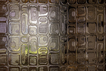 The window light is visible through the decorative door glass. Close up photography.