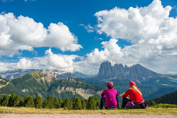 Sporty Young woman friends on mountain trail Dolomites Mountains, Italy