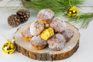Homemade cristmas cupcake, christmas muffins and new yaer decoration on the white background and pine branches and cones